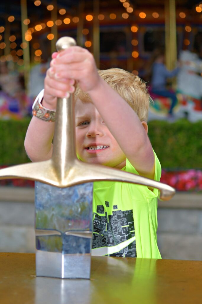 Pulling the Sword from the Stone on a free stay at Disneyland using credit card points
